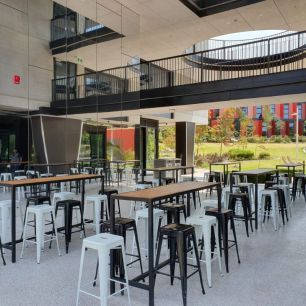 balck and white bar stools around a bar table bench