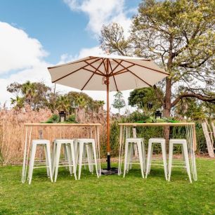 two timber bar benches under an umbrella