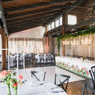 white dancefloor at a wedding in front of the bridal table