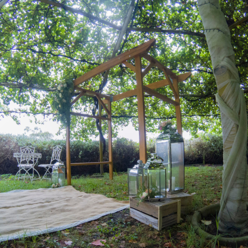 under tree ceremony wooden arch