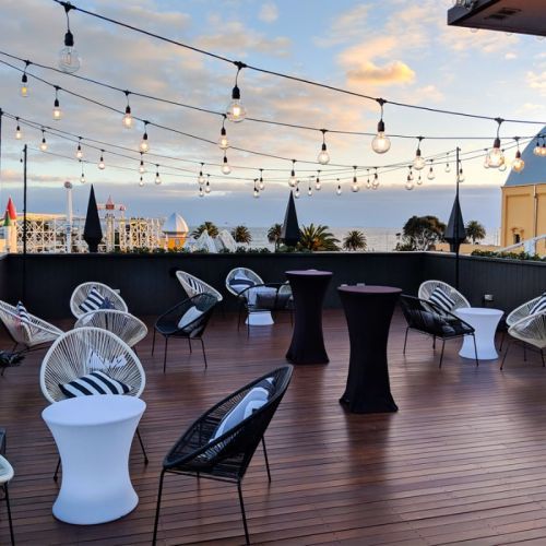 vintage festoon lights over a rooftop bar